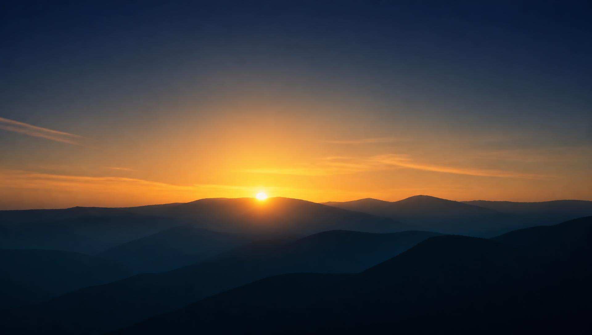 Sunrise breaking over layered ridgelines